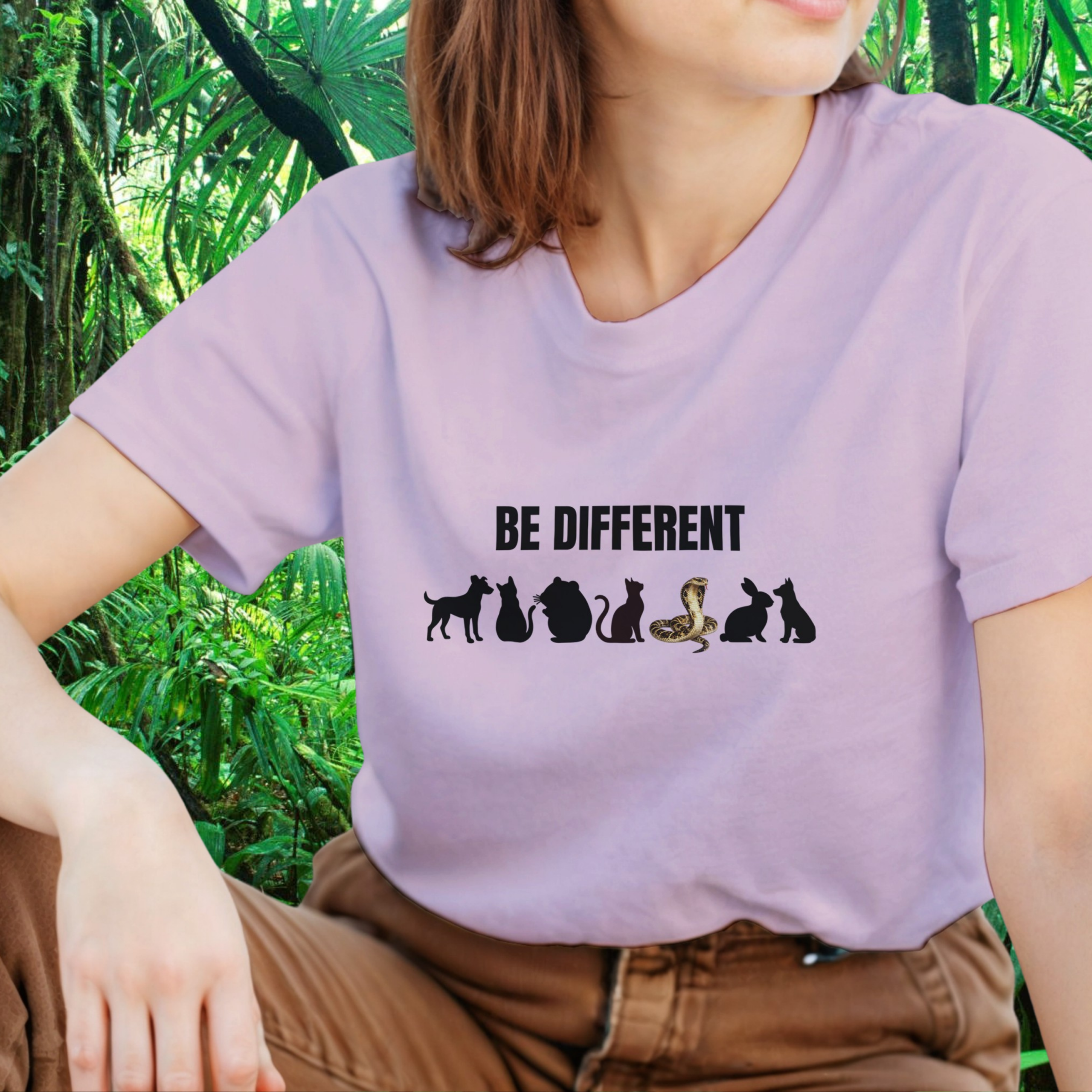 Woman wearing a light pink Be Different Snake shirt